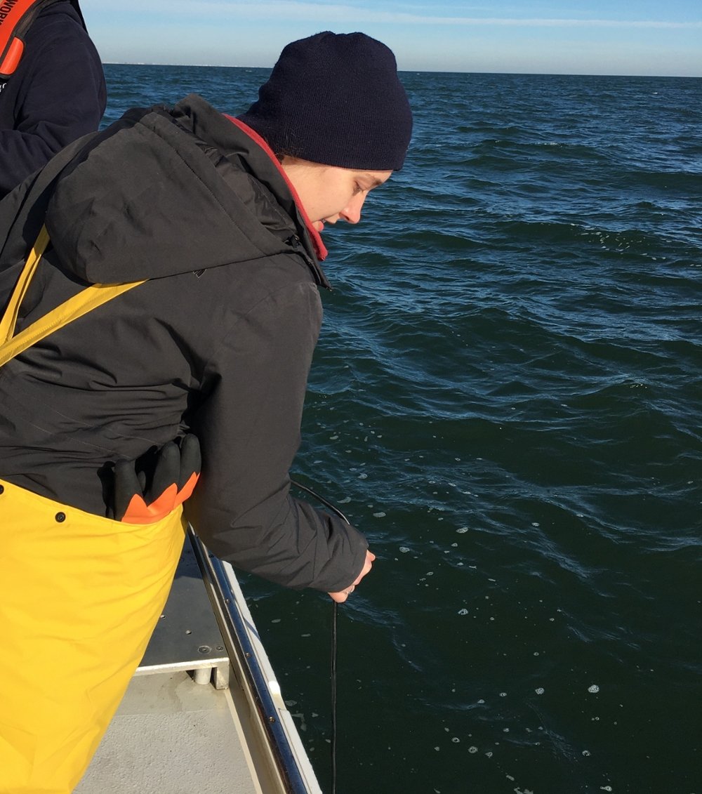 Student doing marine research on a boat