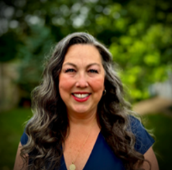 Headshot of Tara Paxton against a forest background