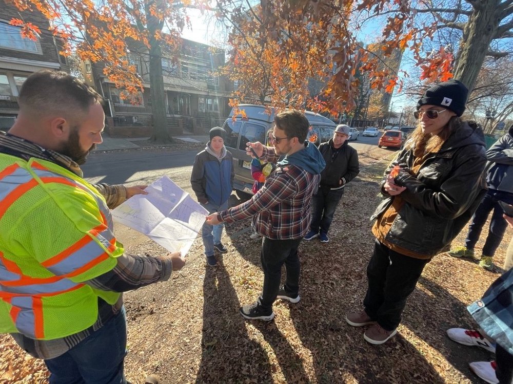 DPS students talking with Darren Bodogh of Asplundh Tree Experts about maps used in municipal tree maintenance (photo credit Zachary Christman)
