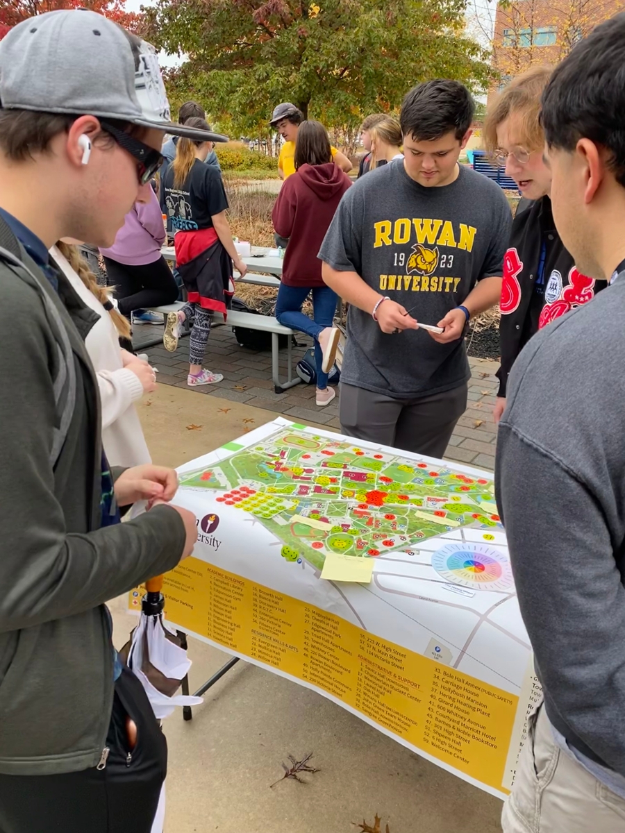 Emotion mapping activity facilitated by Joe Galante, Ike Brecker-Gross and Shane Sloan with Rich Sistad facilitating a Place it! group in the background