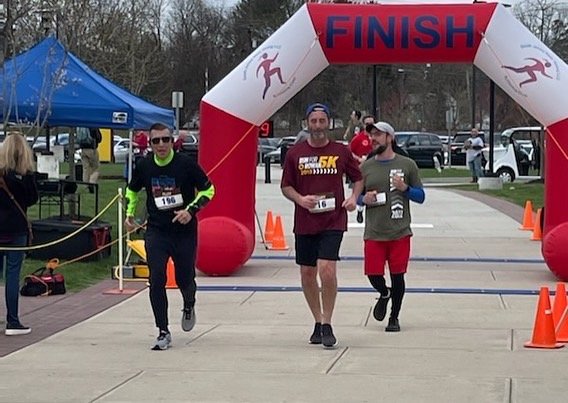 Rich and Ted passing the finish line at Run for Rowan 5K