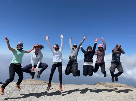 The WHOA women celebrating scaling the Barranco Wall (Ashley York, second from left).