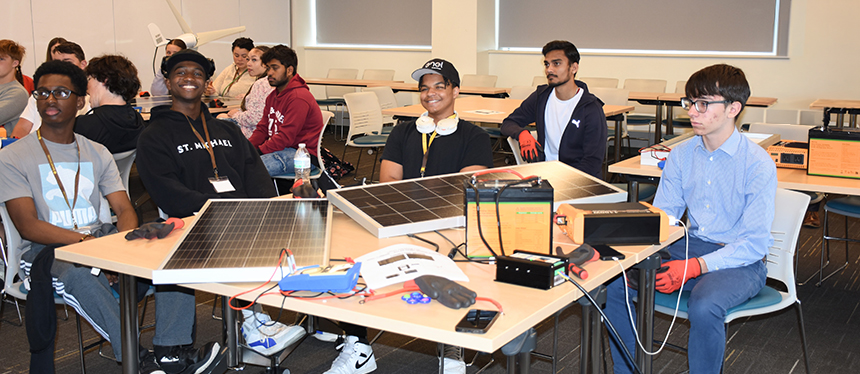 kids at table working on solar panels