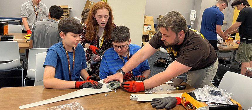 kids working on wind and solar kits at a table
