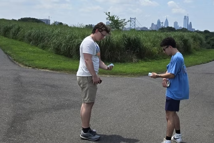 two Rowan students outside doing research