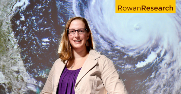 Andra Garner infront of a hurricane map